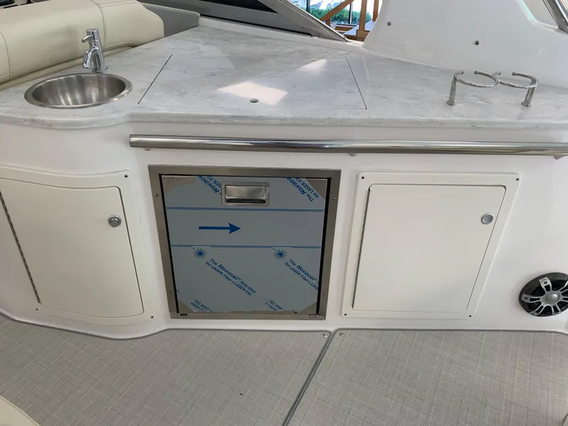 Slide: The Image of 2021 Regal 33 Express yacht kitchenette with sink, storage, and countertop. - 36