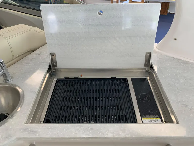 Slide: The Image of Built-in grill on 2021 Regal 33 Express boat, featuring stainless steel and sleek design. - 37