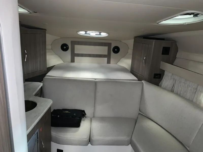 Slide: The Image of 2021 Regal 33 Express cabin interior with modern furnishings and compact design. - 38