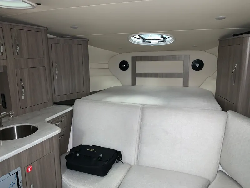 Slide: The Image of Interior of 2021 Regal 33 Express boat with modern cabinetry and seating. - 39