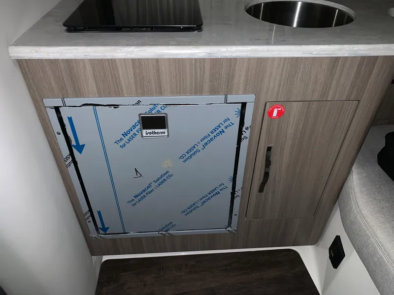 Slide: The Image of 2021 Regal 33 Express interior with wood cabinetry and stainless steel sink. - 41