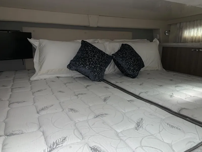 Slide: The Image of Luxurious bed in 2021 Regal 33 Express yacht cabin with decorative pillows. - 43
