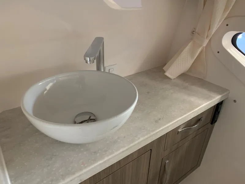 Slide: The Image of 2021 Regal 33 Express bathroom sink with modern faucet and countertop. - 44