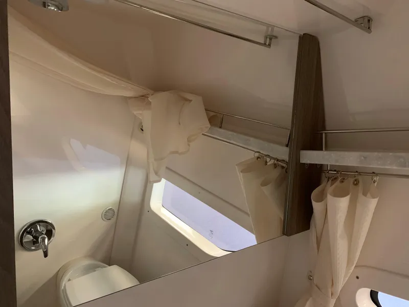 Slide: The Image of 2021 Regal 33 Express bathroom interior with mirror, curtain, and window. - 45