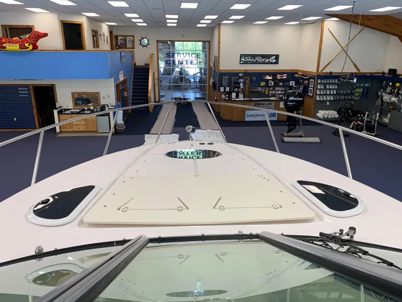 Slide: The Image of 2021 Regal 33 Express boat displayed in a showroom service center. - 47