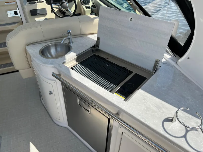Slide: The Image of 2021 Regal 33 Express yacht kitchenette with sink, grill, and storage. - 7