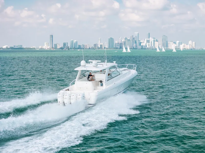 Slide: The Image of 2009 Intrepid 475 Sport Yacht cruising on ocean with city skyline in background. - 10
