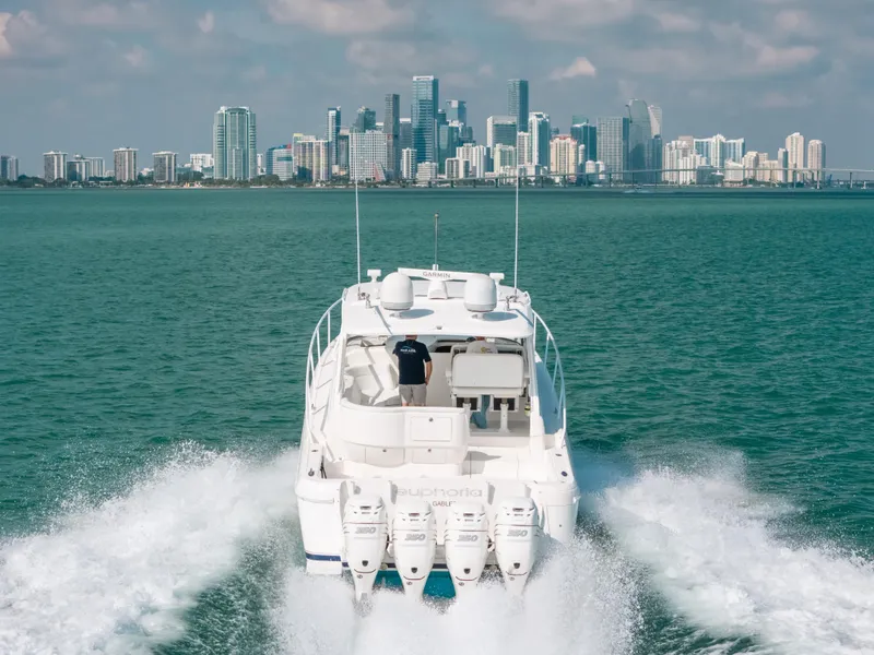 Slide: The Image of 2009 Intrepid 475 Sport Yacht cruising with city skyline in background. - 14