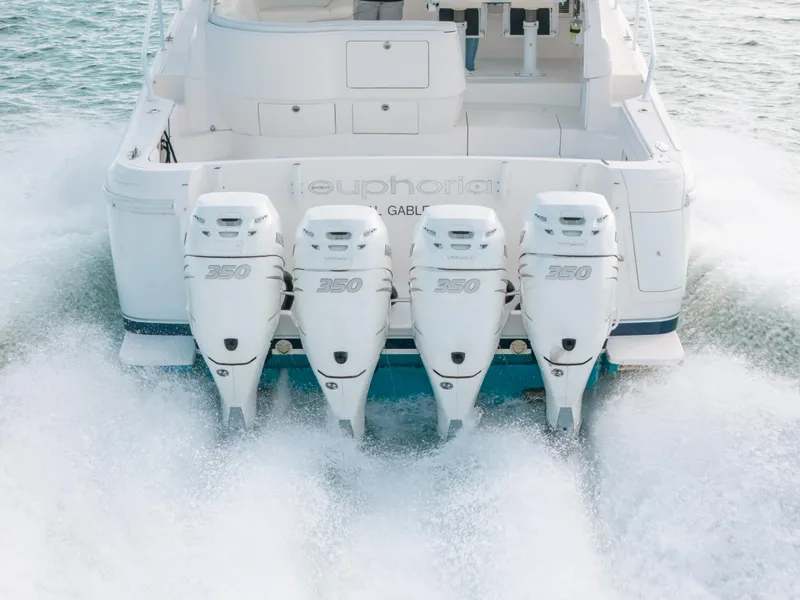 Slide: The Image of 2009 Intrepid 475 Sport Yacht with four powerful outboard engines cruising on water. - 15