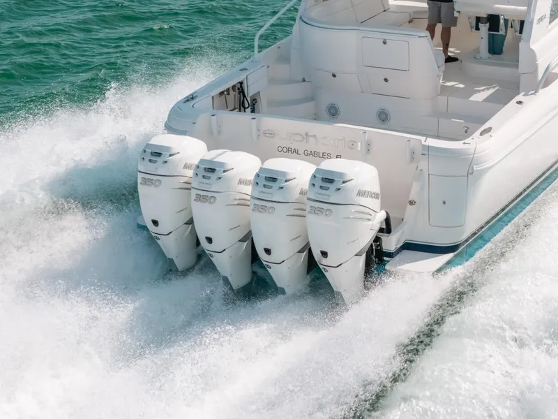 Slide: The Image of 2009 Intrepid 475 Sport Yacht with four powerful outboard engines cruising on water. - 16