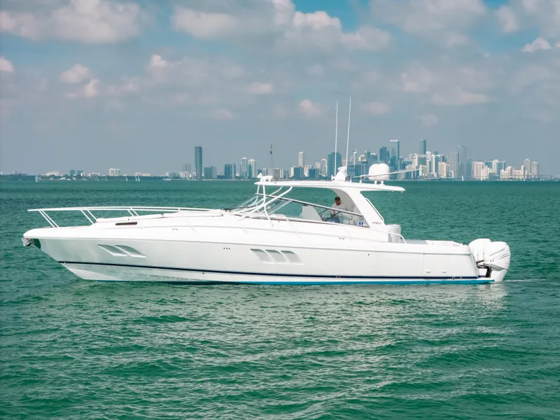 Slide: The Image of 2009 Intrepid 475 Sport Yacht on water with city skyline in background. - 18