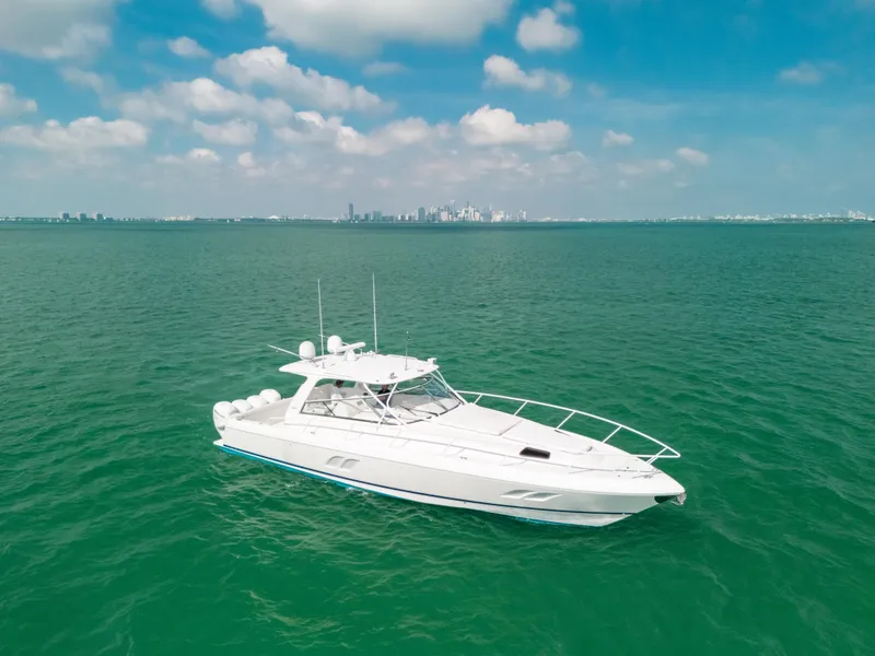 Slide: The Image of 2009 Intrepid 475 Sport Yacht on open water with city skyline in background. - 21