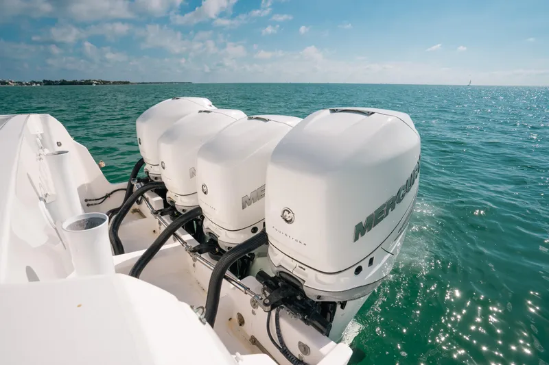 Slide: The Image of Triple Mercury outboard engines on a 2009 Intrepid 475 Sport Yacht in open water. - 28