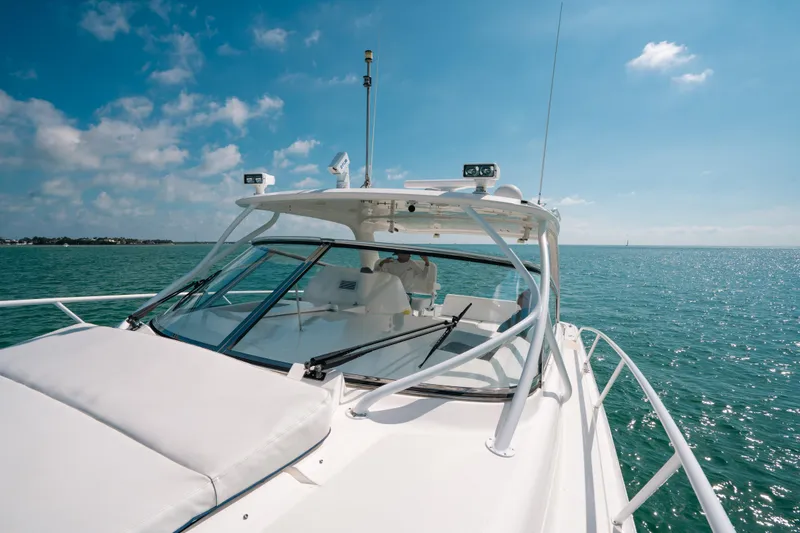 Slide: The Image of 2009 Intrepid 475 Sport Yacht cruising on a sunny day, clear blue waters. - 29