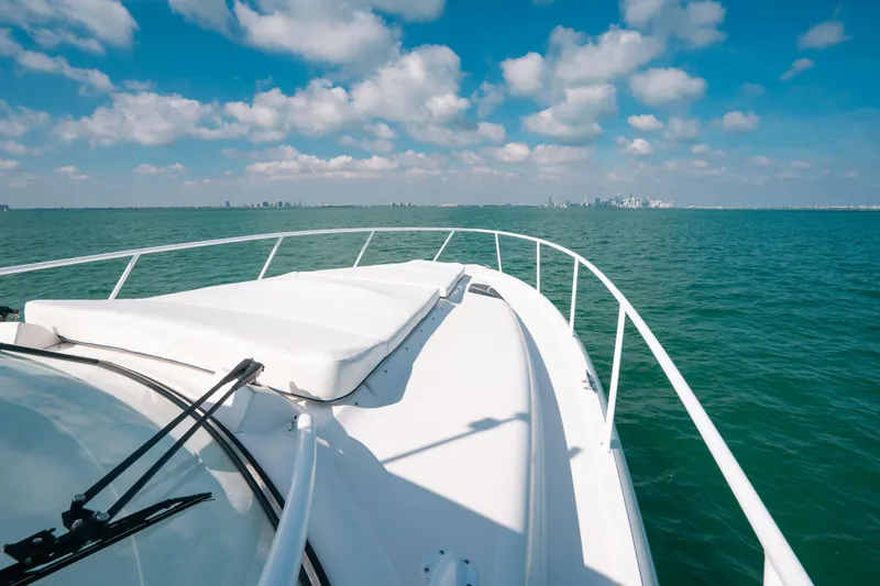 Slide: The Image of 2009 Intrepid 475 Sport Yacht cruising on open water under a blue sky. - 32
