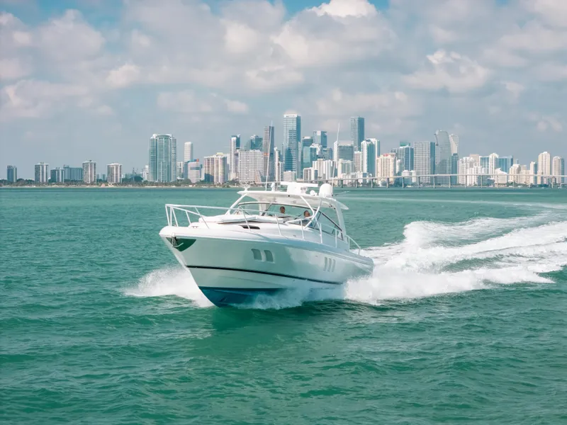 Slide: The Image of 2009 Intrepid 475 Sport Yacht cruising with city skyline in background. - 4