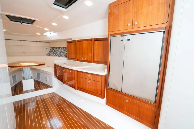 Slide: The Image of Interior of 2009 Intrepid 475 Sport Yacht with wooden cabinetry and sleek design. - 43