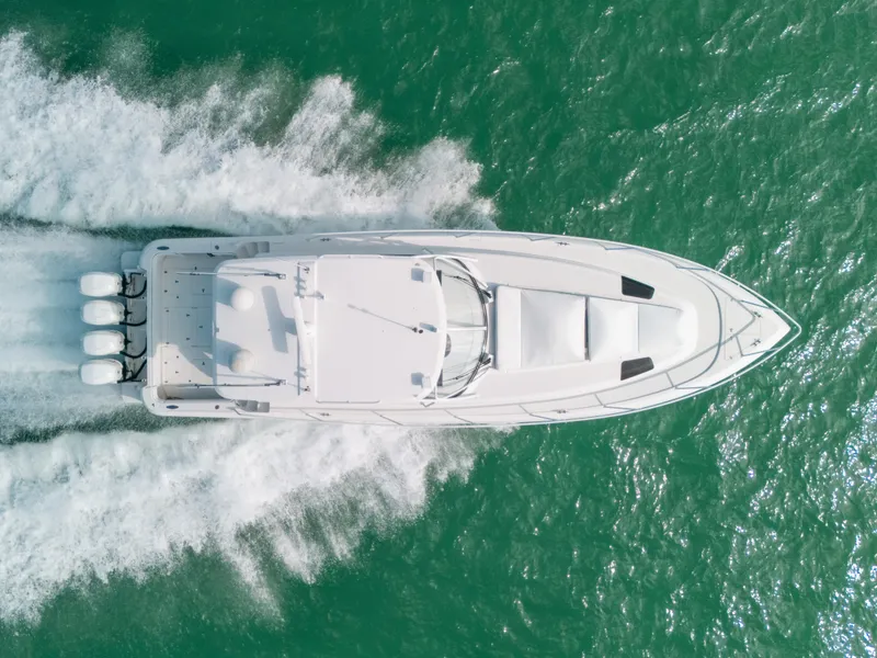 Slide: The Image of Aerial view of 2009 Intrepid 475 Sport Yacht cruising on turquoise water. - 7