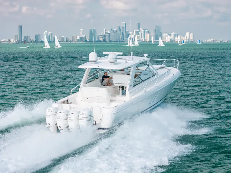 Slide: The Image of 2009 Intrepid 475 Sport Yacht cruising with city skyline in background. - 9