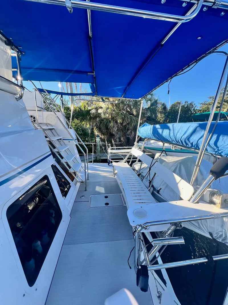 Slide: The Image of 2006 PDQ MV34 boat deck with blue canopy and seating area. - 16