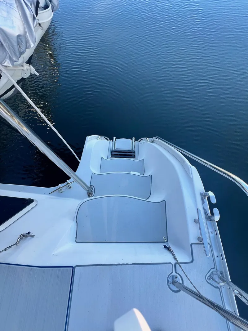 Slide: The Image of 2006 PDQ MV34 boat stern view with steps leading to calm water. - 18