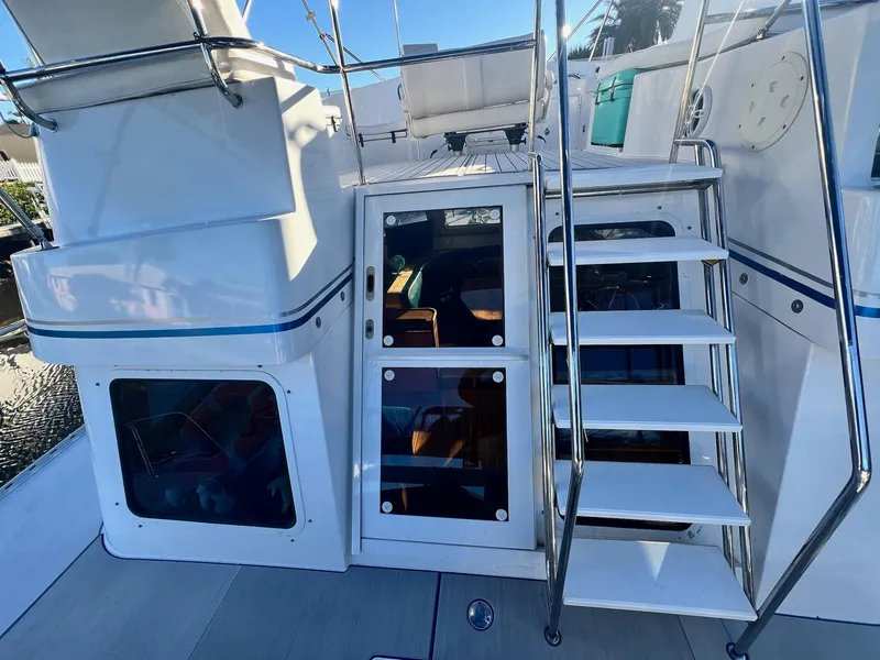 Slide: The Image of 2006 PDQ MV34 yacht with stairs and cabin entrance, featuring sleek white design. - 20