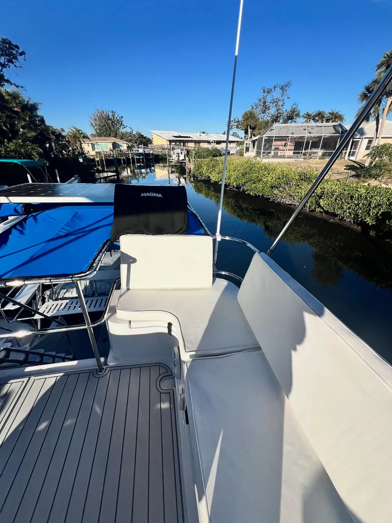 Slide: The Image of 2006 PDQ MV34 boat on a canal, featuring seating and clear blue skies. - 28