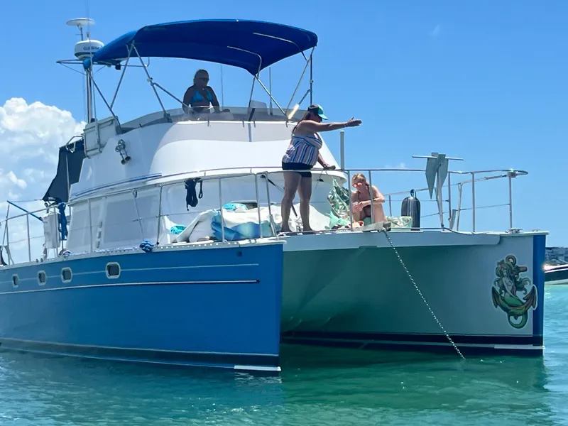 Slide: The Image of 2006 PDQ MV34 boat with people enjoying sunny day on the water. - 3