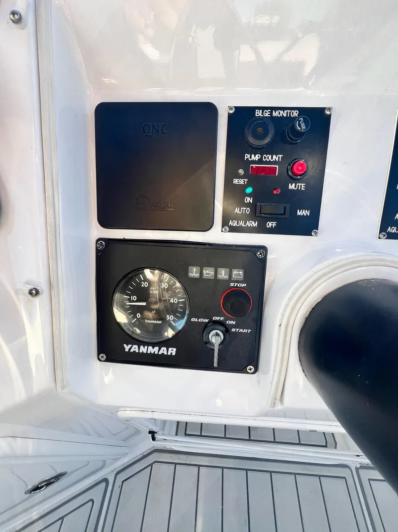 Slide: The Image of Control panel of a 2006 PDQ MV34 boat with Yanmar engine gauges. - 33
