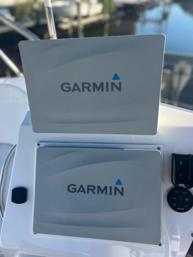 Slide: The Image of Garmin navigation screens on a 2006 PDQ MV34 boat dashboard. - 34