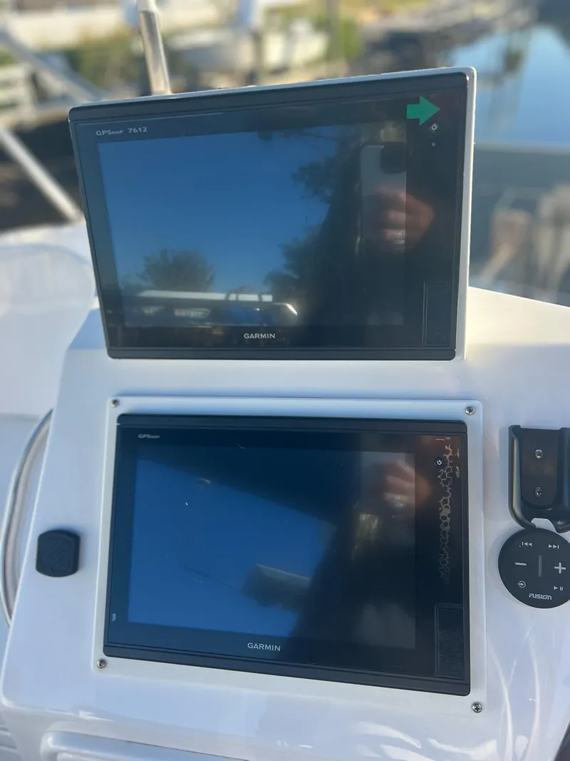 Slide: The Image of Dual Garmin displays on a 2006 PDQ MV34 boat dashboard. - 35