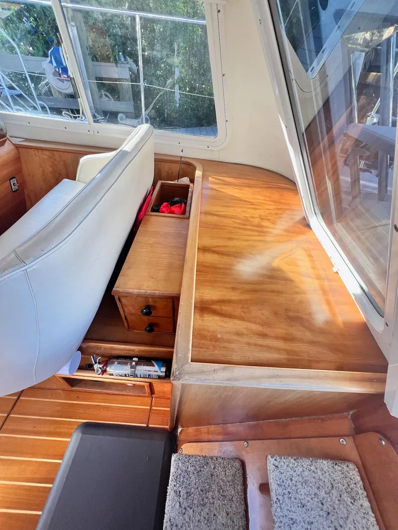 Slide: The Image of Interior of a 2006 PDQ MV34 boat with wooden surfaces and seating. - 43