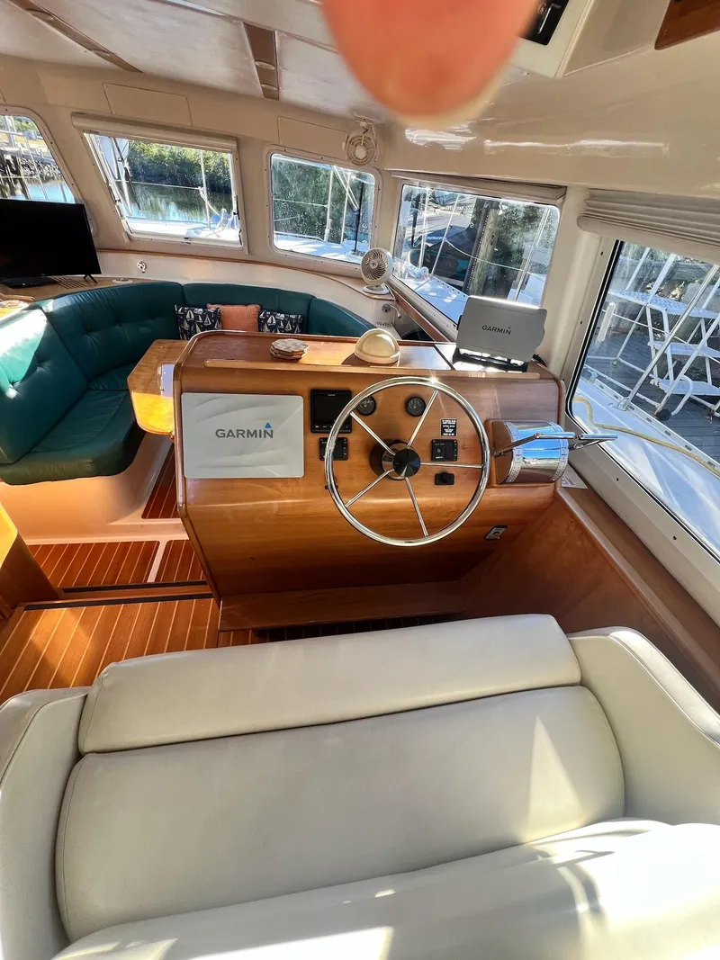 Slide: The Image of Interior of a 2006 PDQ MV34 boat with steering wheel and Garmin navigation system. - 46