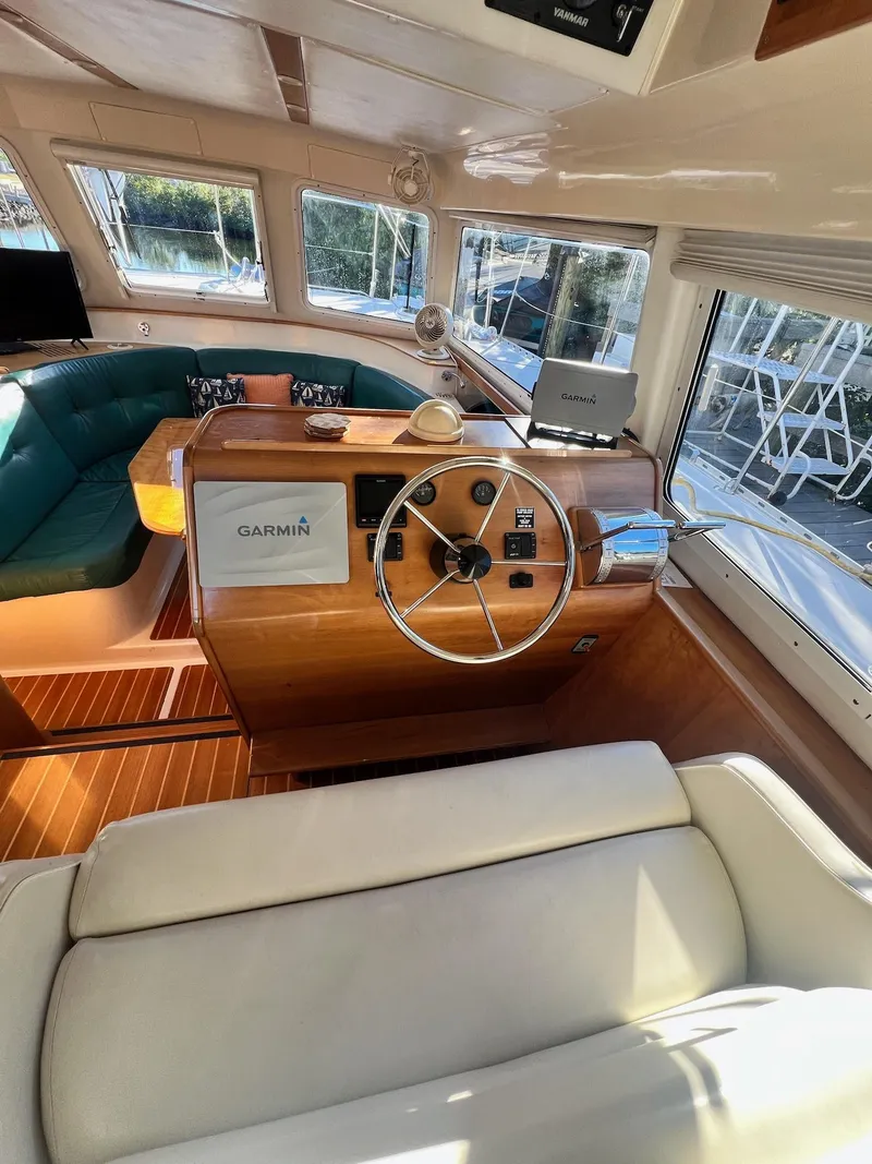 Slide: The Image of Interior of a 2006 PDQ MV34 boat with wooden helm and Garmin navigation system. - 49