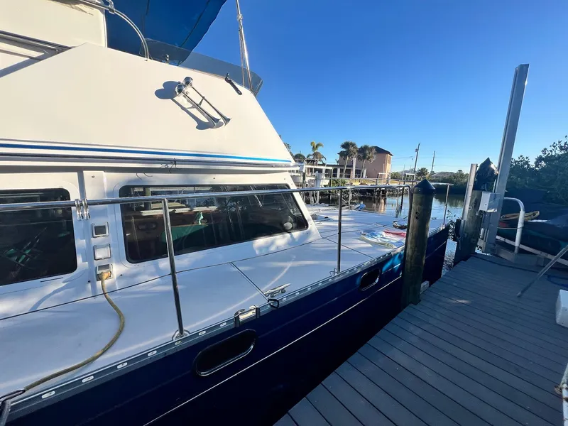 Slide: The Image of PDQ MV34 2006 boat docked at marina under clear blue sky. - 6