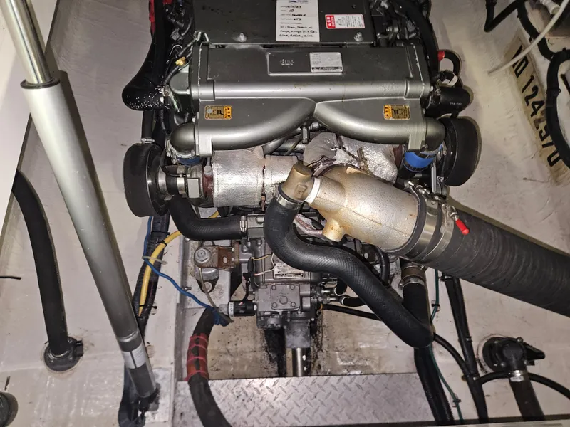 Slide: The Image of Engine compartment of a 2012 Back Cove 30 boat, showcasing detailed mechanical components. - 10