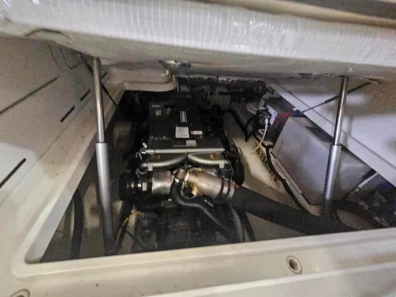 Slide: The Image of Engine compartment of a 2012 Back Cove 30 boat, showcasing mechanical components. - 15