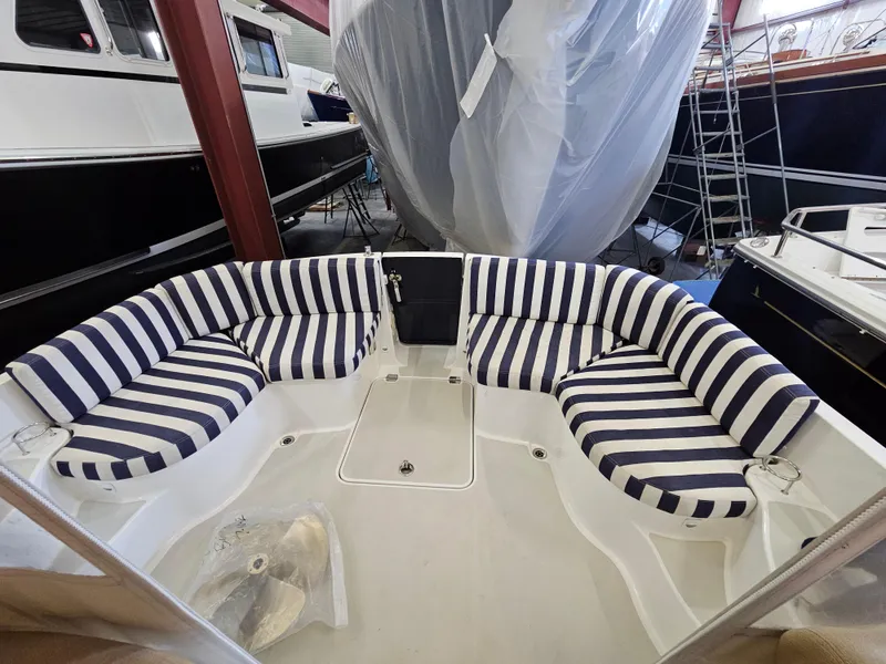 Slide: The Image of 2012 Back Cove 30 boat with striped seating in a storage facility. - 29