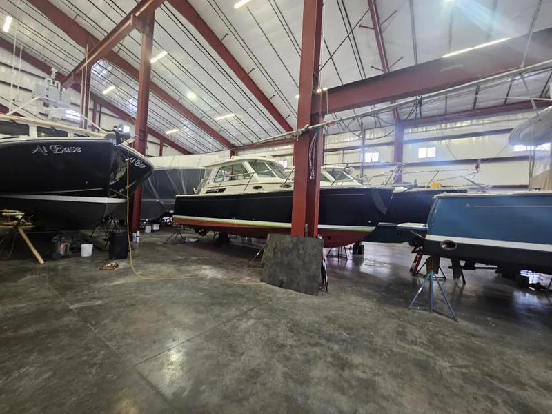 Slide: The Image of 2012 Back Cove 30 boat in a spacious indoor storage facility. - 3