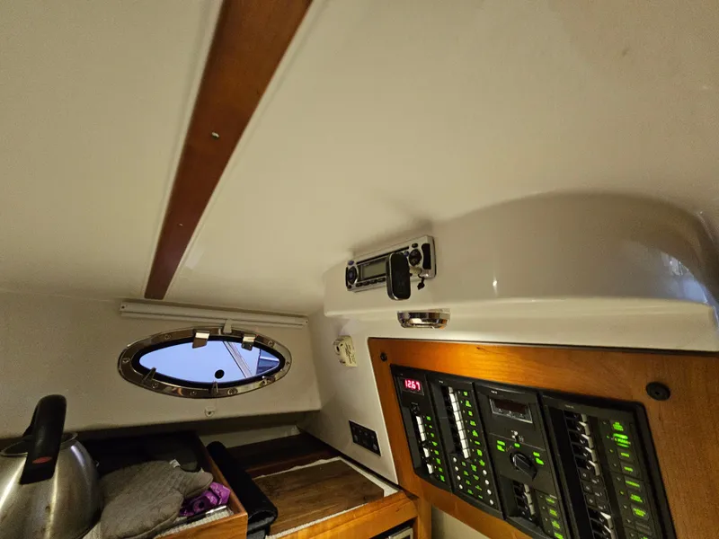 Slide: The Image of Interior of 2012 Back Cove 30 boat with control panel and porthole. - 30