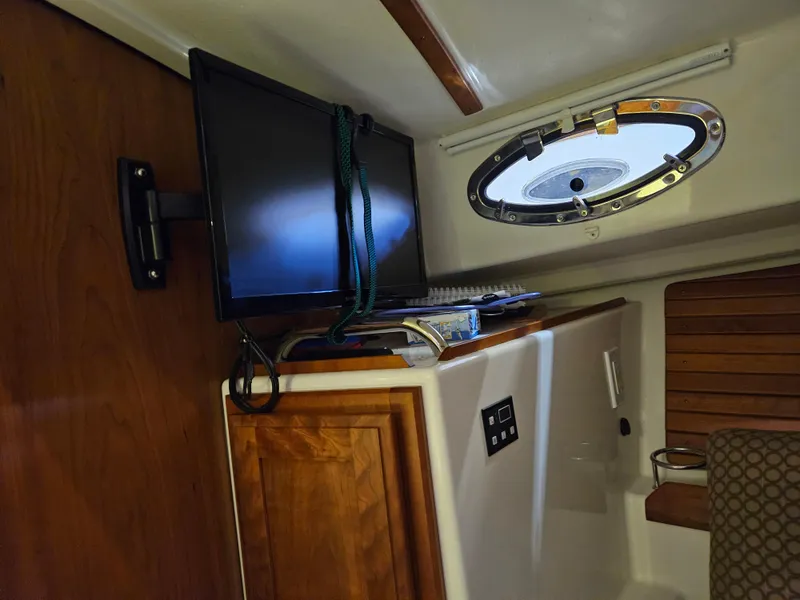Slide: The Image of Interior of a 2012 Back Cove 30 boat with TV and porthole. - 31