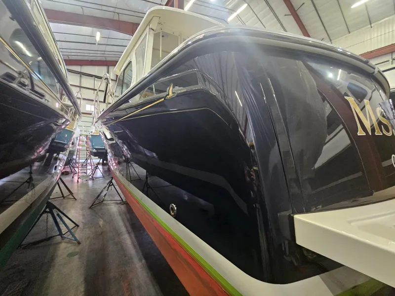 Slide: The Image of 2012 Back Cove 30 boat in a storage facility, side view. - 6