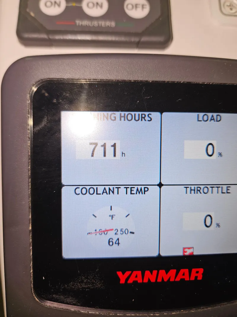 Slide: The Image of Yanmar engine display showing 711 hours, 0% load, 64°F coolant temperature on a 2012 Back Cove 30. - 9