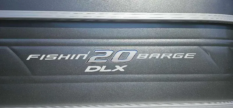 Slide: The Image of 2024 Sun Tracker Fishin' Barge 20 DLX logo on metallic surface. - 2