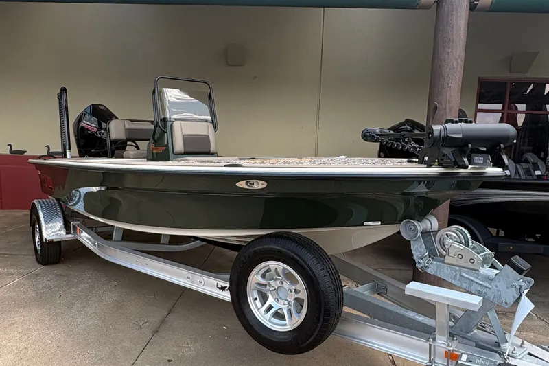 Slide: The Image of A green 2025 Mako 18 Pro Skiff boat is on a trailer. - 2