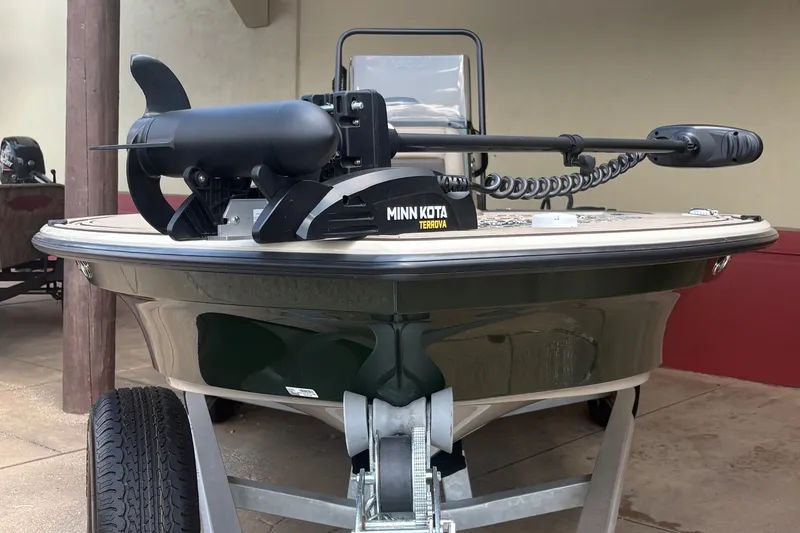 Slide: The Image of 2025 Mako 18 Pro Skiff Backwater Edition with Minn Kota trolling motor, on a trailer. - 1