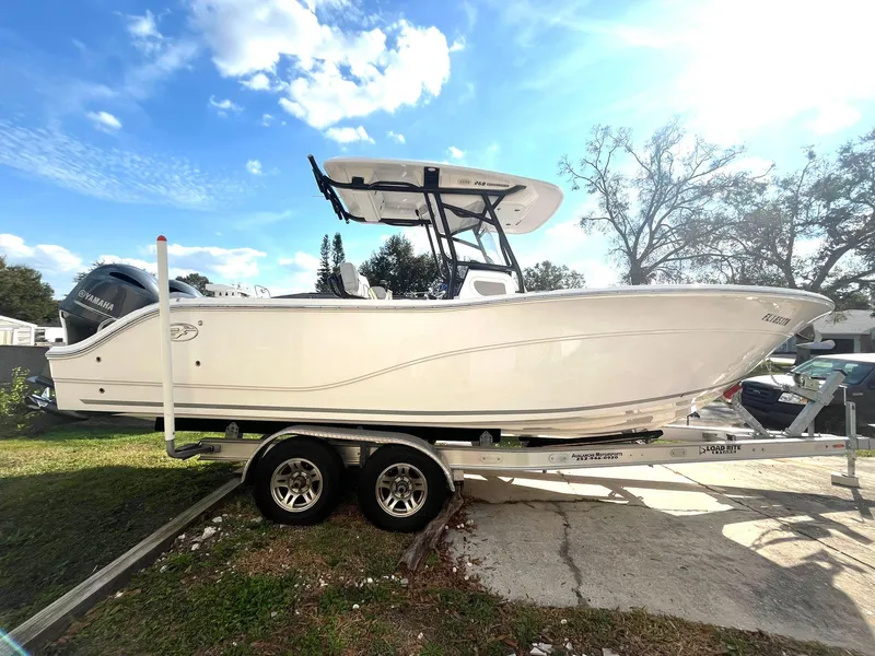 Slide: The Image of 2023 Sea Fox 268 Commander boat on trailer under a sunny sky. - 0
