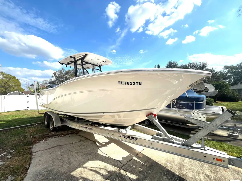 Slide: The Image of 2023 Sea Fox 268 Commander boat on trailer under blue sky. - 1