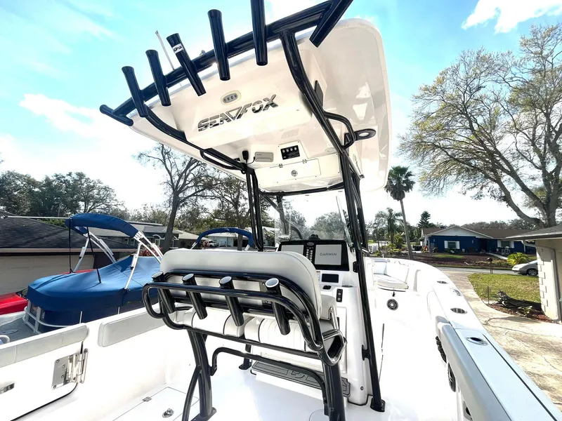 Slide: The Image of 2023 Sea Fox 268 Commander boat interior with helm and seating, under a clear sky. - 21