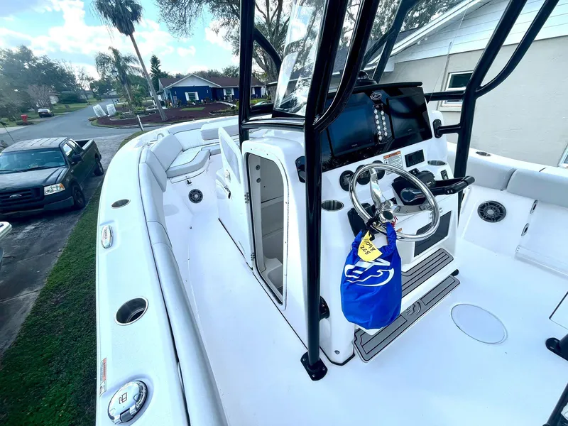 Slide: The Image of 2023 Sea Fox 268 Commander boat interior with steering console and seating. - 23